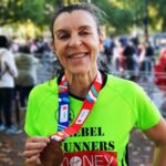 Carina at the London Marathon, smiling and holding her medal